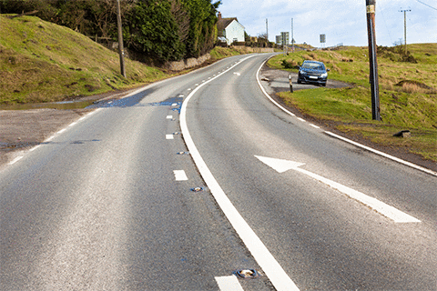 Alertness - What does this curved arrow road marking mean?