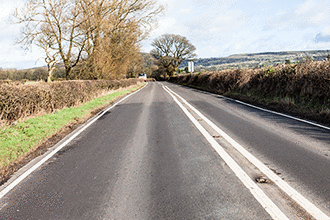 Road and traffic signs - When may you cross a double solid white line in the middle of the road?