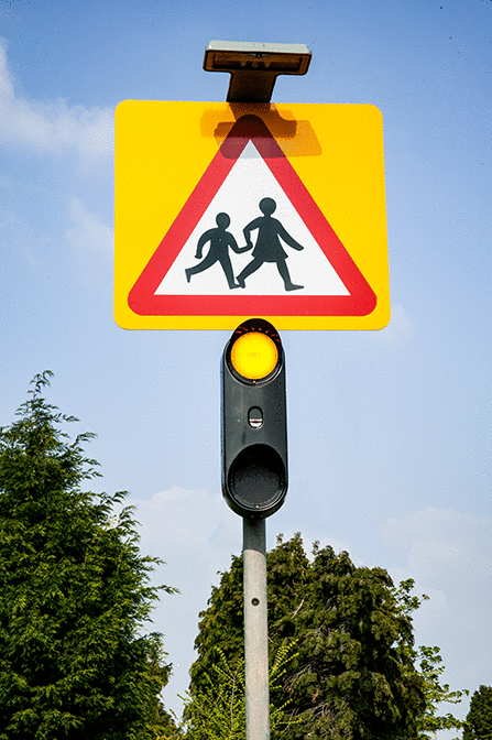 Vulnerable road users - What action should you take when you see flashing amber lights under a school warning sign?