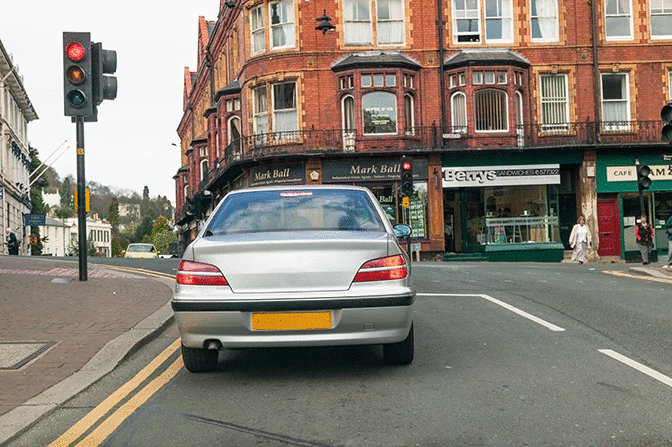 Hazard awareness - You intend to turn left at the traffic lights. What should you do just before turning?