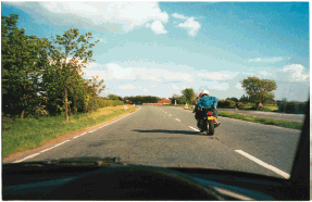 Hazard awareness - You've just been overtaken by this motorcyclist. What should you do if the rider cuts in sharply?