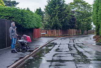 The road - The road is wet. Why should you slow down as you approach this pedestrian?