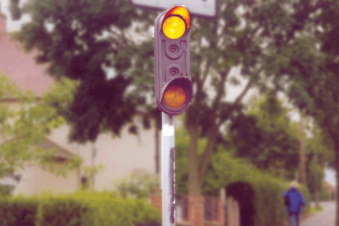 The road - You're driving in town and see these lights flashing. What would you expect to see ahead?