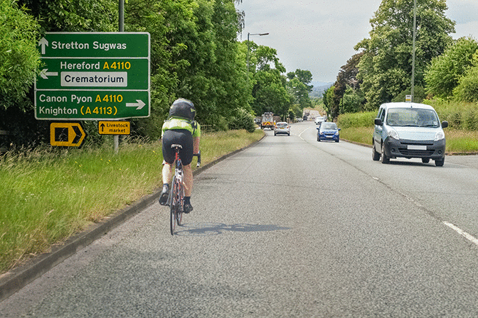 Other road users - You're following a cyclist. What should you do if you wish to turn left a short distance ahead?