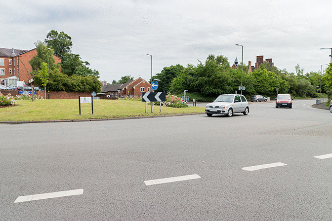 Road and traffic signs - What does this line across the road at the entrance to a roundabout mean?