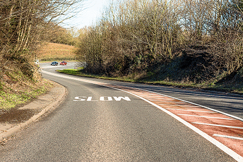 Road and traffic signs - What's the reason for the hatched area along the centre of this road?